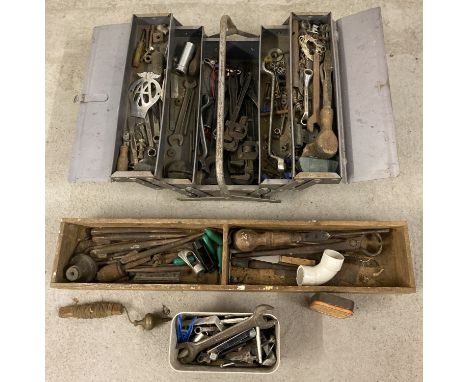 A metal cantilever toolbox and contents to include adjustable spanners and other spanners. Together with a wooden tray of ass