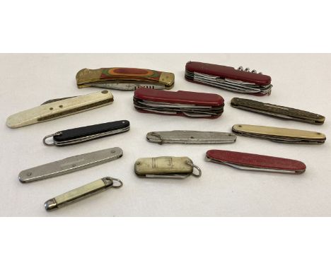 12 vintage and modern penknives in varying sizes and designs. To include engine turned detail, advertising and Swiss army sty