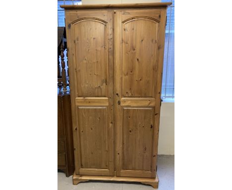 A modern  Lavenham double pine wardrobe with interior shelf and hanging rail. Complete with key. Approx. 183 x 95 x 55cm.