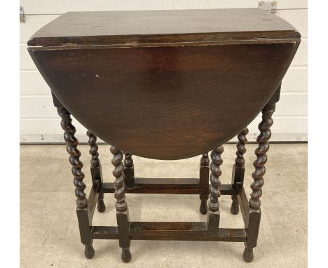 A small vintage dark oak drop leaf, gate leg barley twist table.  Approx. 72cm tall x 59 cm unextented.