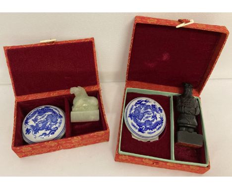 2 boxed Chinese soapstone seal and ink paste sets. Each box containing a different carved seal together with a blue and white