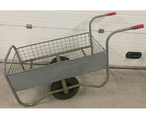 A vintage galvanised metal wheelbarrow/trolley with large rubber tyres.  Body measures 99 x 57cm.