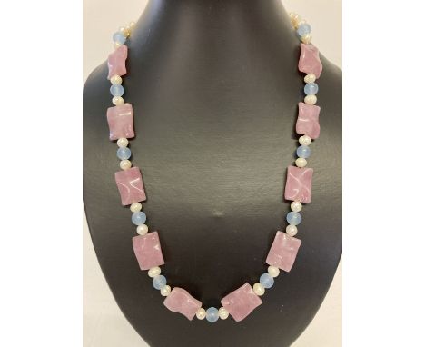A 22" fresh water pearl necklace with pink and blue jade beads and gold tone hook clasp.  