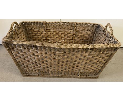 A large vintage wicker laundry basket with carry handles.  Approx. 38 x 82 x 52cm.