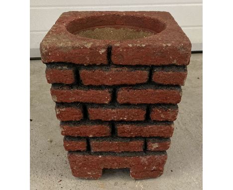 A vintage red and black painted brick design cement garden planter with drainage hole.  Approx. 39cm tall x 30cm across.