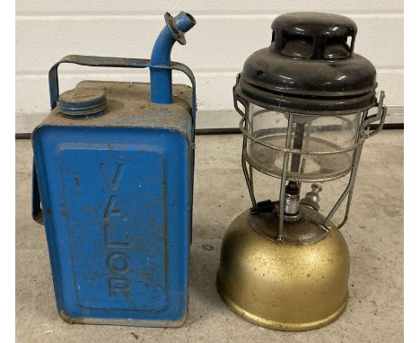 A vintage Tilley lamp together with a blue Valor paraffin can.  