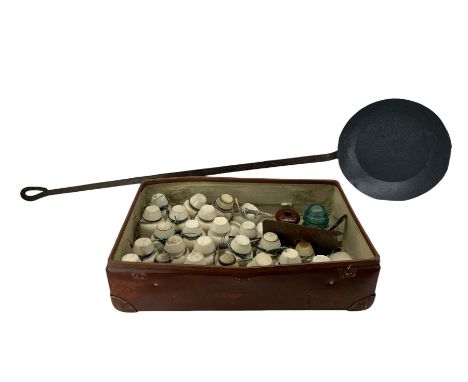 Collection of LNER telegraph pole and other ceramic insulators, one with bracket, together with a wrought iron frying pan 