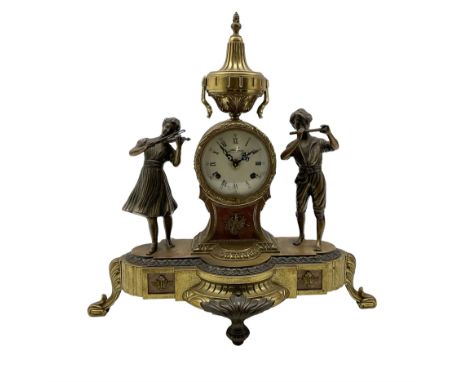 20th century - continental 8-day mantle clock, drum cased movement surmounted with a conical urn and flanked by two cast figu