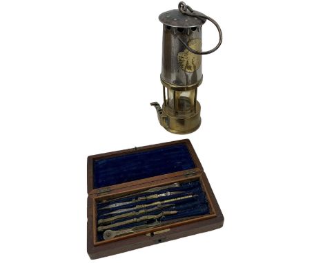 Set of 19th century drawing instruments in mahogany case and a brass and steel miners lamp (2)