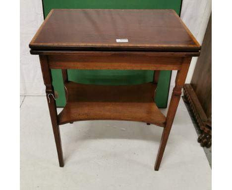 Small Edw. Mahogany and inlaid fold-over card table raised on square tapering supports with under-tier