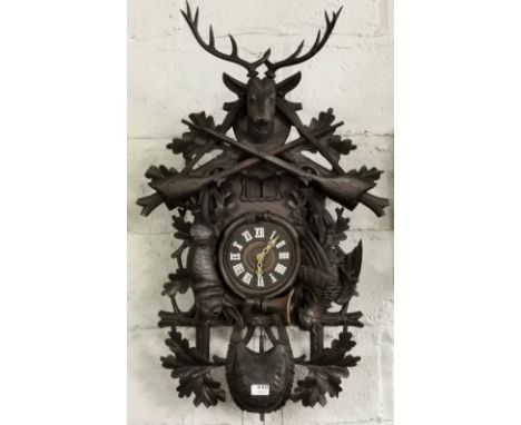 Large South American Cuckoo Clock, highly carved with game bird side reliefs of a rabbit and a pheasant with a stag’s head fi