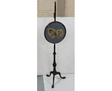 Victorian mahogany Pole Screen with oval Berlin woolwork banner decorated with a pekinese, raised on a turned column and trip