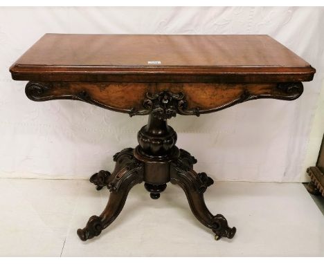 Victorian Walnut Foldover Card Table, fine quality, with a floral carved and serpentine shaped freize, on a pod base with 4 s