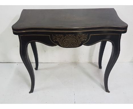 Regency Ebonised Card Table, serpentine shaped, on sabre legs, brass inlaid throughout, folds over to reveal a red baize inte