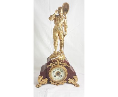 French Mantel Clock, mounted with a spelter figure of an Oarsman, gold painted and on a red marble base having lion paw front