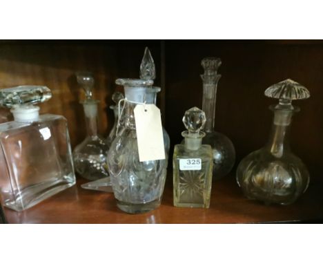 Shelf containing a quantity of various 19th C &amp; later Cut Glass Decanters including one large Chanel