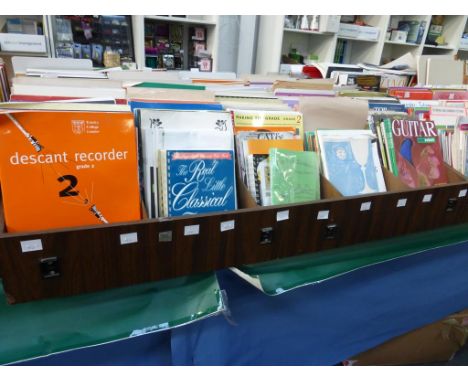 Five divided shelves of music literature to include ''Guitar Grade 2 Rock School'', ''Gilbert and Sullivan HMS Pinafore (perf