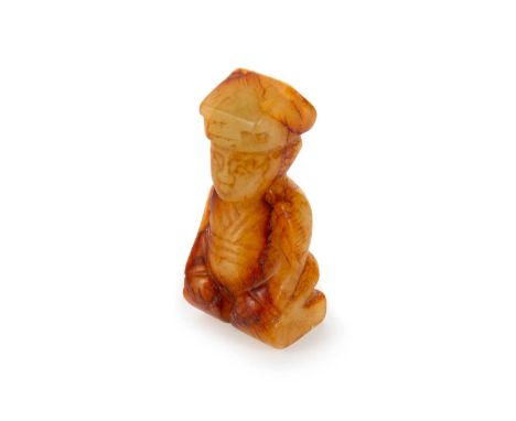 CHINESE RUSSET JADE CARVING, 20TH CENTURY modelled as a figure, posed in a kneeling position5.6cm high