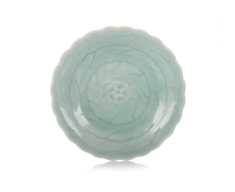 CHINESE CELADON DISH, 19TH CENTURY decorated with flower head, seal mark to base18cm diameterA few small chips to base rim, v