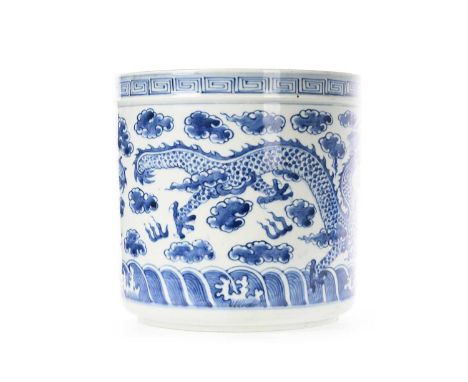 CHINESE BLUE AND WHITE PLANTER, EARLY 20TH CENTURY  of cylindrical form, decorated with dragons chasing the flaming pearl, un
