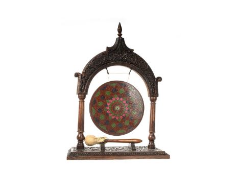 INDIAN HARDWOOD DINNER GONG, LATE 19TH/EARLY 20TH CENTURY the finial above carved archway on two turned column supports, rais