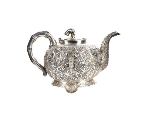 CHINESE EXPORT SILVER TEA POT AND SPOON, EARLY 20TH CENTURY  the tea pot with stylised bamboo handle, the body richly embosse