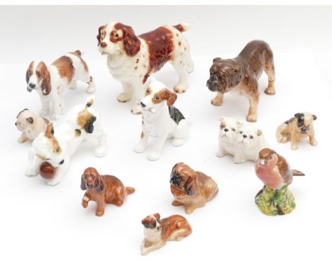 Twelve ceramic models of animals, eleven depicting dogs and the twelfth being a robin, makers to include, Beswick and Royal D