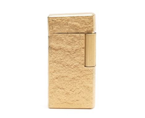 Alfred Dunhill Ltd; A Dunhill 70 gas pocket cigarette lighter, bark effect gold plated in presentation case with instructions
