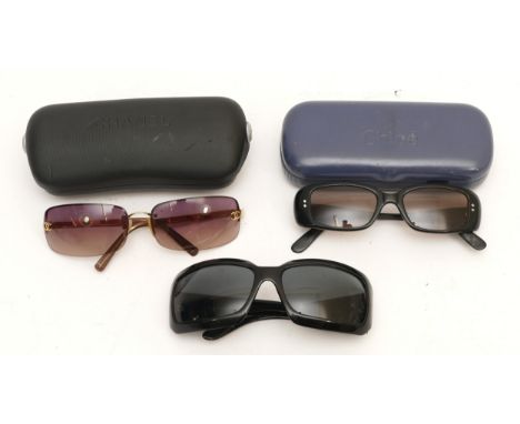 Three pairs of ladies designer sunglasses, to include a cased pair of Chloe and two pairs of Chanel sunglasses.