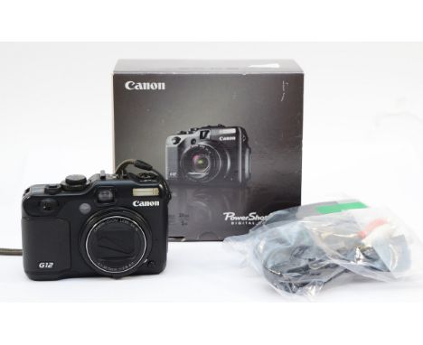 A Canon PowerShot G12 digital camera, in box. Unable to test (two pin plug adapter needed) It does have a battery, memory car