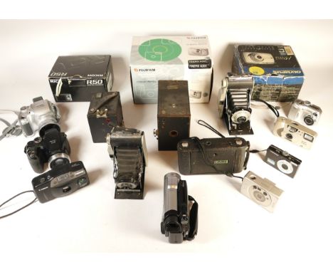 A collection of cameras and camera accessories, to include, a Fujifilm Finepix S5700, Nikon Coolpix 3100, and Canon Sureshot 