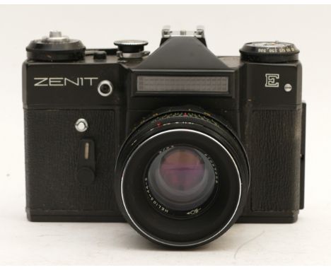 A Zenit-E 35mm film camera with Helios-44-2 f/2 58mm lens, in case together with two Carl Zeiss Pro-Tessar lenses, one being 