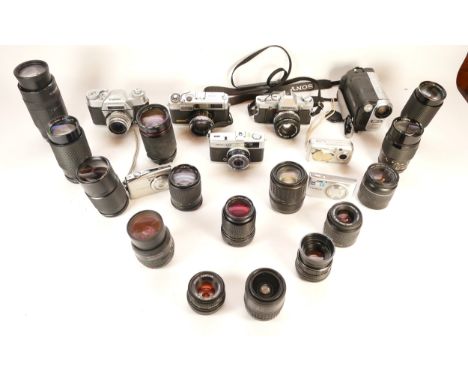 A collection of cameras and camera accessories, to include, an Olympus OM30, a Carl Zeiss Jena f/3.5 135mm lens and a Canon E