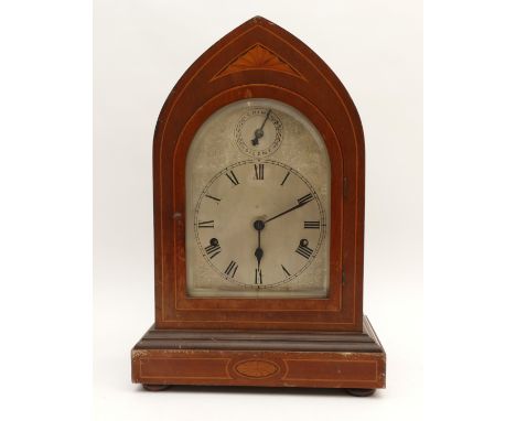 An Edwardian mahogany cased lancet-shaped mantel clock, with a silvered dial featuring a subsidiary chime/silent dial, striki