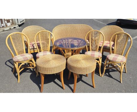 A suite of ten bamboo and cane furniture pieces, to include a two seater sofa, two matching chairs, a round glass topped dini