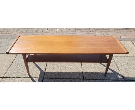 A mid 20th century teak coffee table, the rectangular top with shelf below, on tapered legs, 113x38cm.