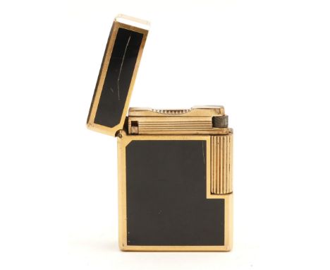 S.T.Dupont Paris; A ladies sized Dupont pocket cigarette lighter, gold plated with black enamelled panelled sides.