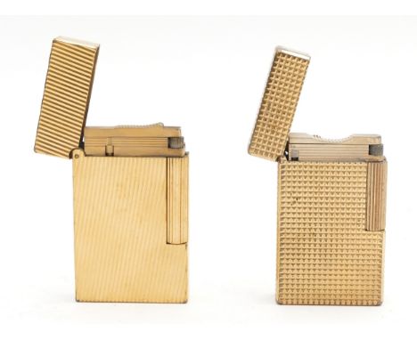 S.T. Dupont Paris; Two Dupont gold plated cigarette lighters, gents size, gas operated, having hobnail and ribbed pattern, fu