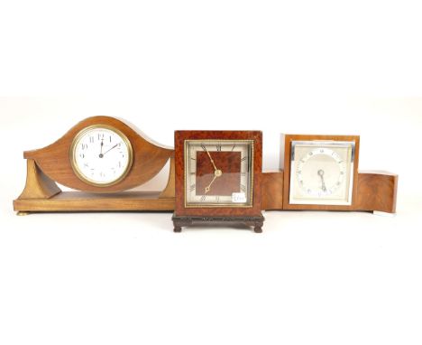 Three mahogany cased clocks, in the style of Art Deco, one being Elliot with a silvered dial, engraved with a rose, and a Tho
