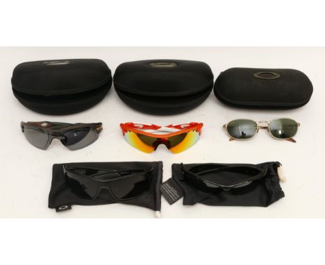 Five pairs of Oakley fashion sunglasses, three cased and two in soft carry cases. (5)