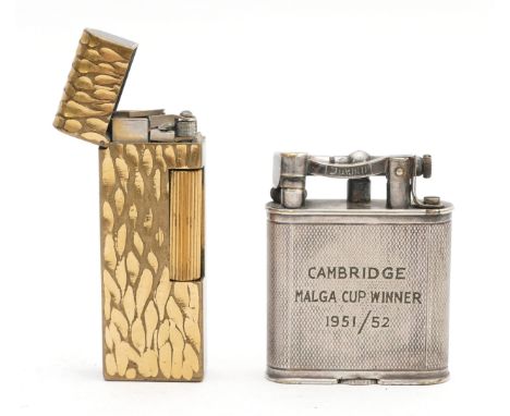 Alfred Dunhill London; A 1950s gents Dunhill lift arm pocket cigarette lighter, petrol operated, silver plated engine turned 