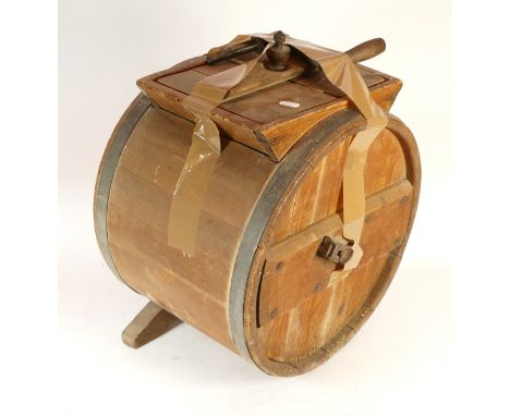 A vintage table-top wooden butter churn.
