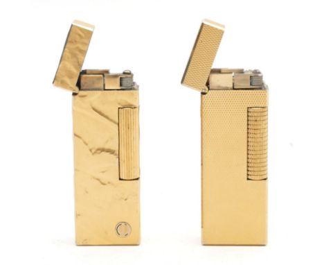 Alfred Dunhill London; Two gold plated Dunhill Rollagas cigarette lighters, having engine turned and tree bark decoration. (2
