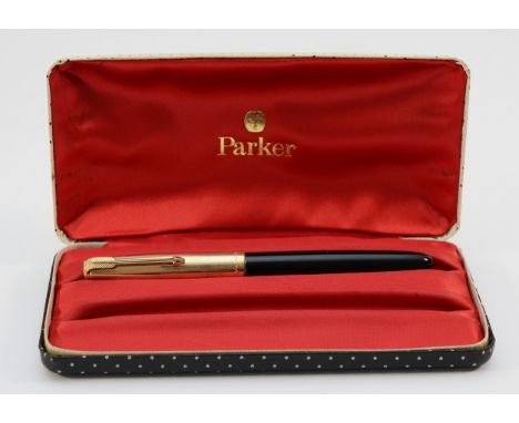 A Parker 51 fountain pen, squeeze action filled, with red satin lined case.