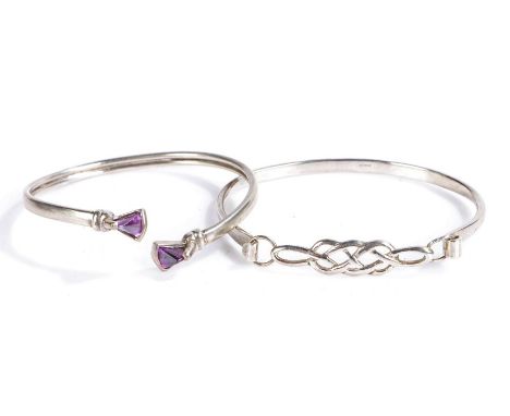 Two silver bangles, one with Celtic design the other set with two amethysts (2)