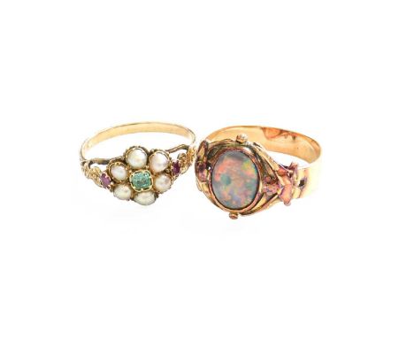 An Opal Ring, the oval cabochon opal in a yellow rubbed over setting, within a yellow foliate design frame, to a forked shoul