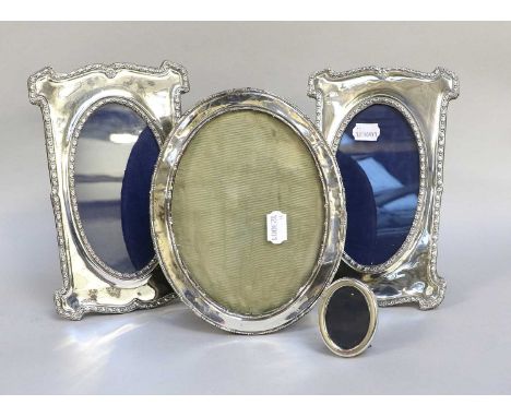 Four Various Silver Photograph-Frames, two shaped oblong and with oval aperture, another oval (4) The two oblong examples in 