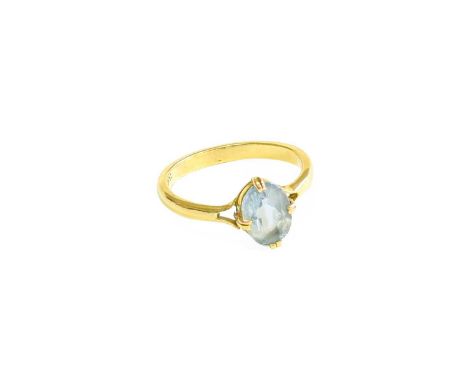 An Aquamarine Ring, the oval cut aquamarine in a yellow double claw setting, to a plain polished shank, finger size N1/2Stamp