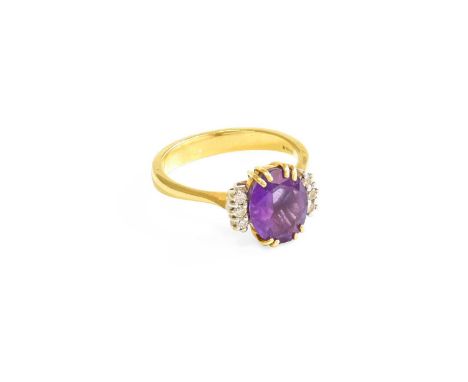 An 18 Carat Gold Amethyst and Diamond Ring, the oval cut amethyst in a yellow double claw setting, flanked by trios of round 