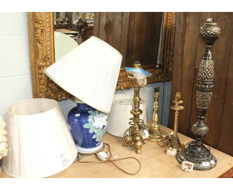 A Large Black Gilt and Enamel Table Lamp, dated 1970, three brass table lamps, three new modern lampshades and two modern mac